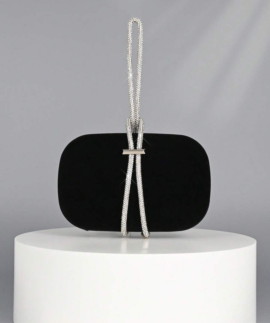 Turn heads at every event with this Elegant Satin Box Clutch. Its sleek black satin finish paired with sparkling crystal embellishments adds just the right touch of glam to your outfit. Compact yet chic, it’s perfect for carrying your essentials while dancing the night away or mingling at parties. A little sparkle goes a long way—make every moment shine with this playful, luxurious accessory.
