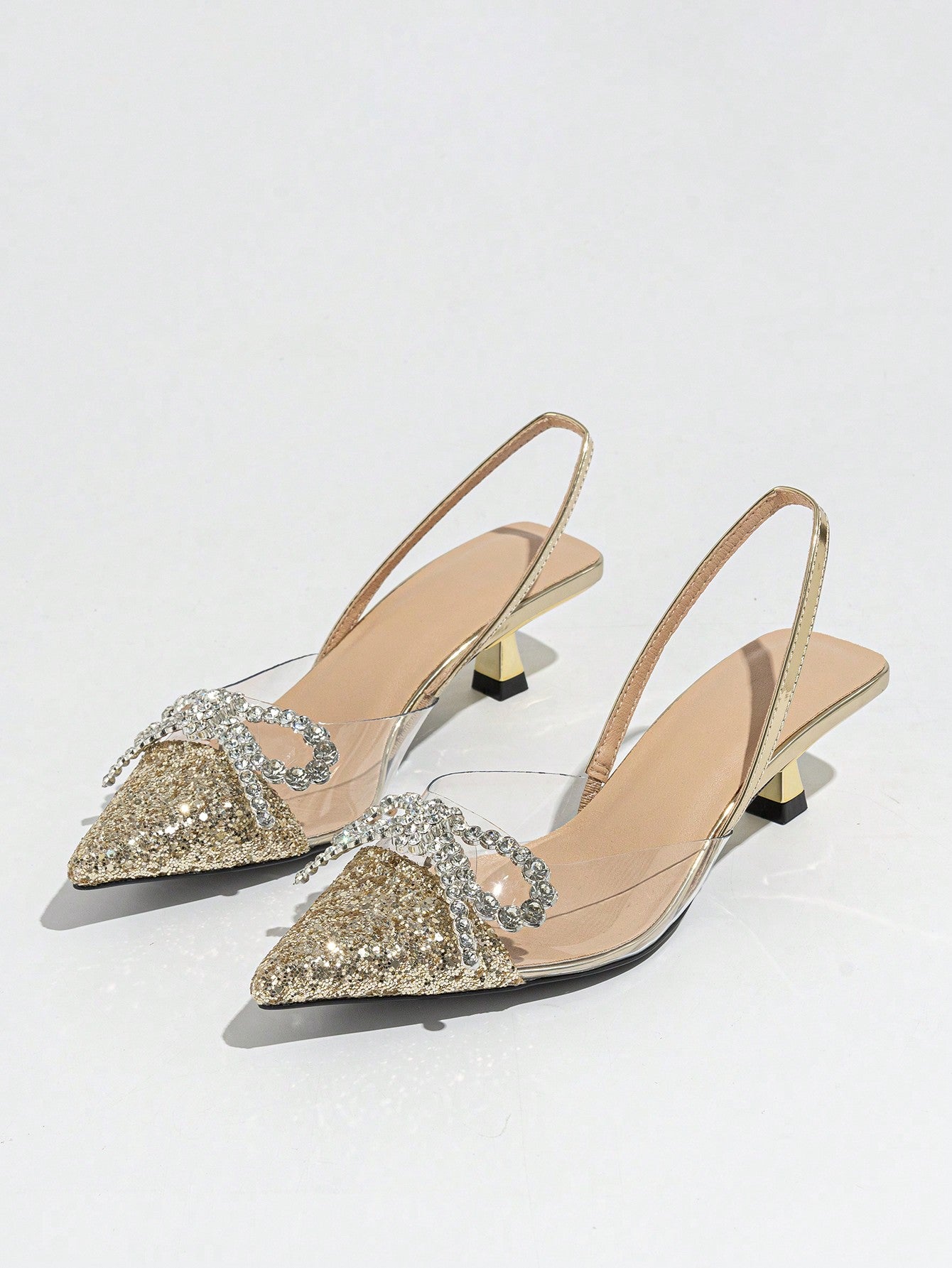 Step into sparkle with these Elegant Silver Pointed Toe Slingback Pumps! Featuring a dazzling rhinestone bow, they add just the right touch of glam to your wedding or formal event outfit. The sleek pointed toe and slingback design keep things chic and comfortable, so you can dance the night away with confidence and style. Perfect for making every step shine!