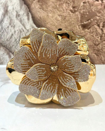 Elevate your evening look with this stunning flower-shaped acrylic clutch. Crafted from premium PMMA material and adorned with shimmering silver rhinestones, this mini bag brings sophistication to any occasion. The secure magnetic closure keeps your essentials safe, while the delicate chain strap offers elegant versatility—wear it as a clutch or over your shoulder. Perfect for weddings, parties, and special events, this novelty purse combines glamorous design with practical functionality.
