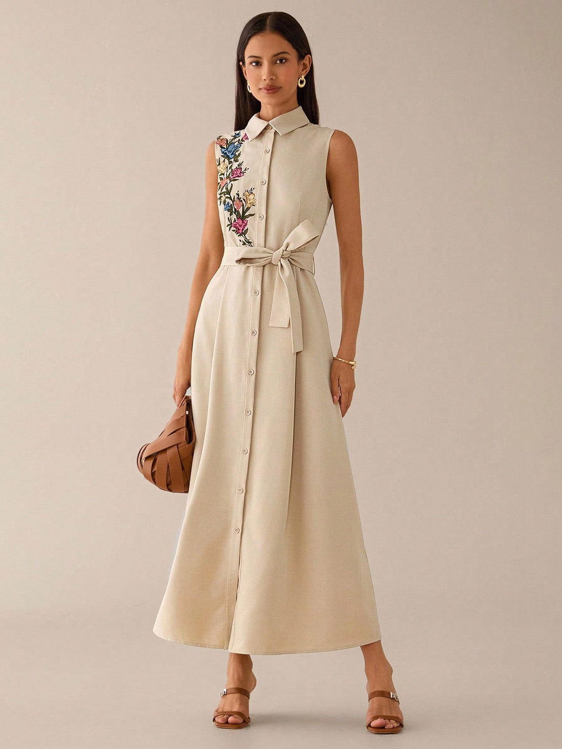 Step out in style with this elegant sleeveless embroidered shirt dress, perfect for both urban adventures and romantic evenings. Its delicate embroidery adds a touch of charm, while the sleeveless design keeps you cool and comfortable all day. Whether you're strolling through the city or enjoying a date night, this dress effortlessly blends sophistication with playful ease.
