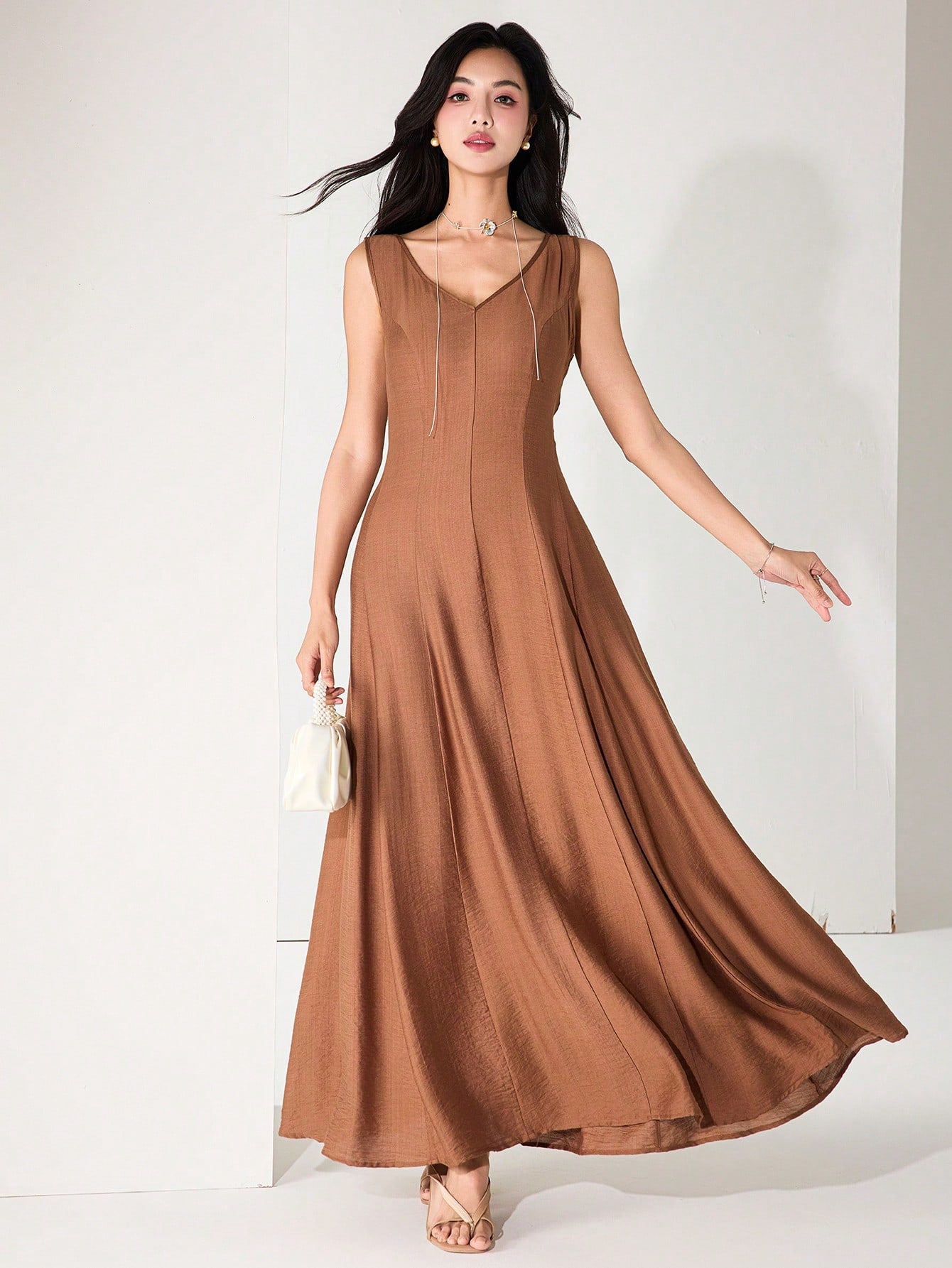 Twirl into summer with our sleeveless flared hem dress that's equal parts elegant and fun! This breezy number keeps you cool during warm days while the flattering silhouette ensures you'll stand out at any graduation ceremony. From accepting diplomas to celebrating afterward, this versatile dress transitions effortlessly from formal moments to casual festivities!