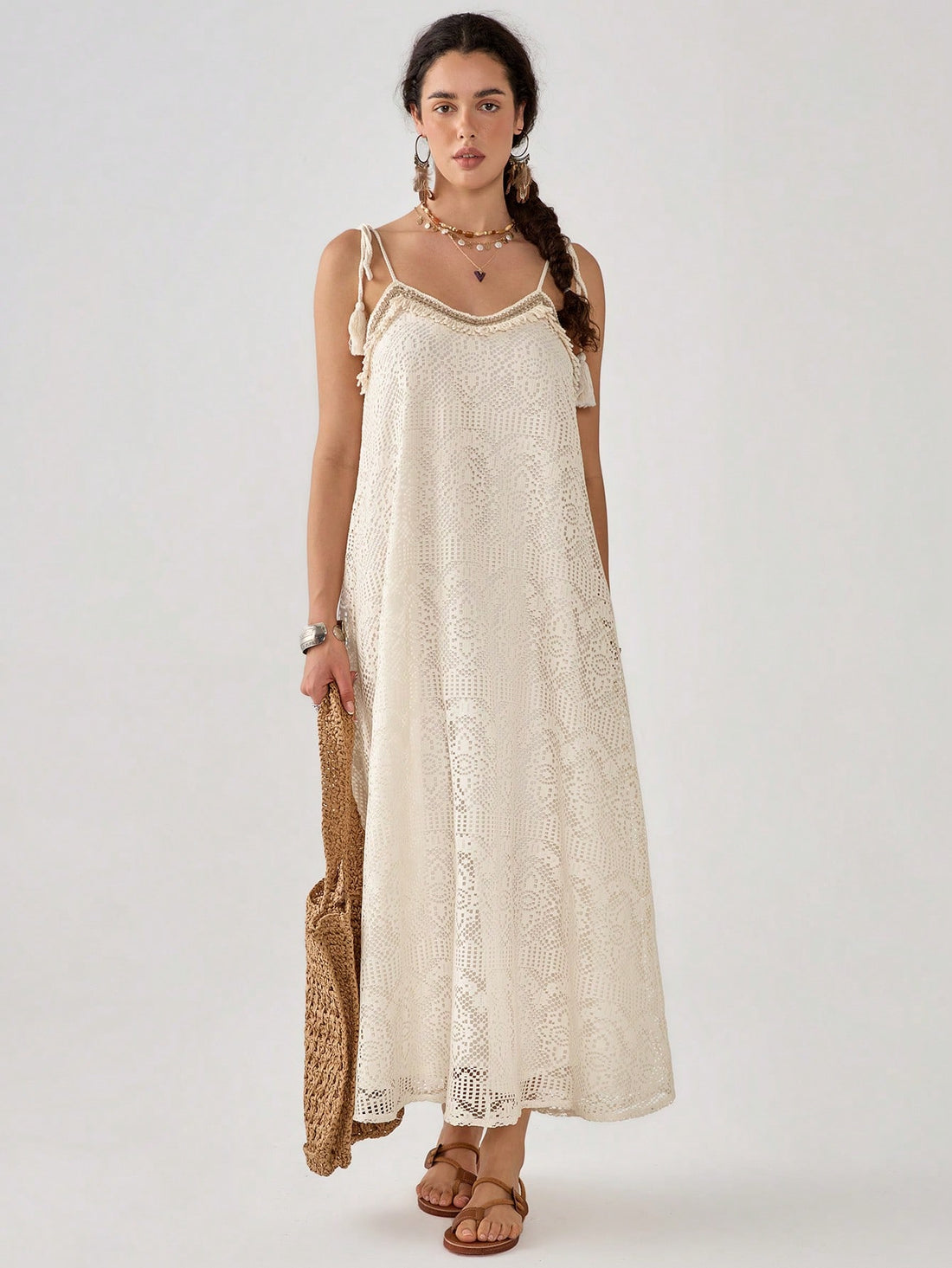 Twirl into the season with our breezy sleeveless slip dress! This playful number features eye-catching hollow-out details and a loose, flowy fit that dances with every step. Perfect for sunny brunches or moonlit strolls, it's the carefree wardrobe hero your spring and summer adventures have been waiting for!