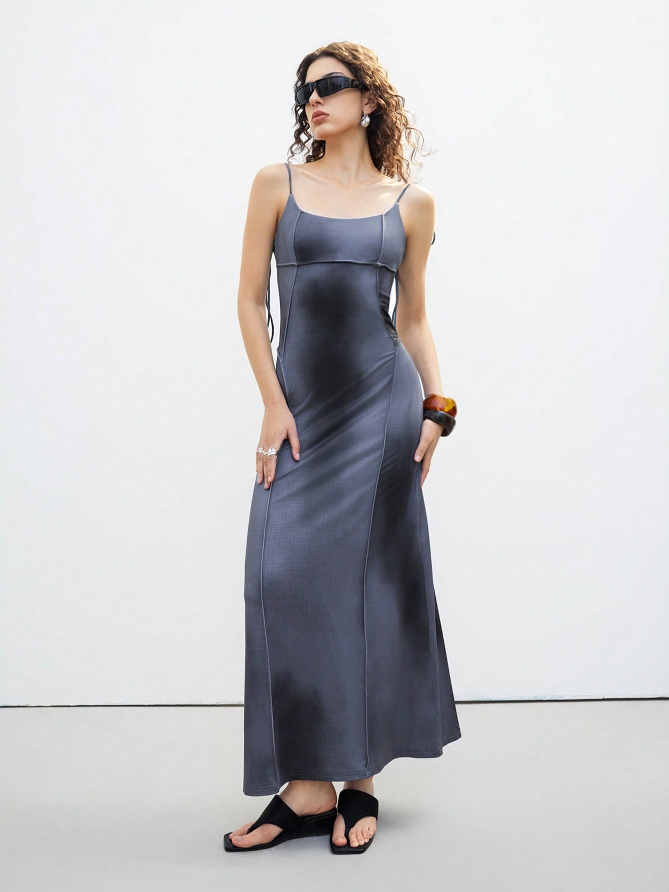 Step out in style with this playful and elegant sleeveless midi dress. Featuring delicate spaghetti straps and a charming tie-back detail, it offers a flirty yet sophisticated look perfect for any occasion. The flattering midi length adds a touch of grace, making it your go-to dress for sunny days or evening fun. Embrace effortless elegance with a twist of whimsy!