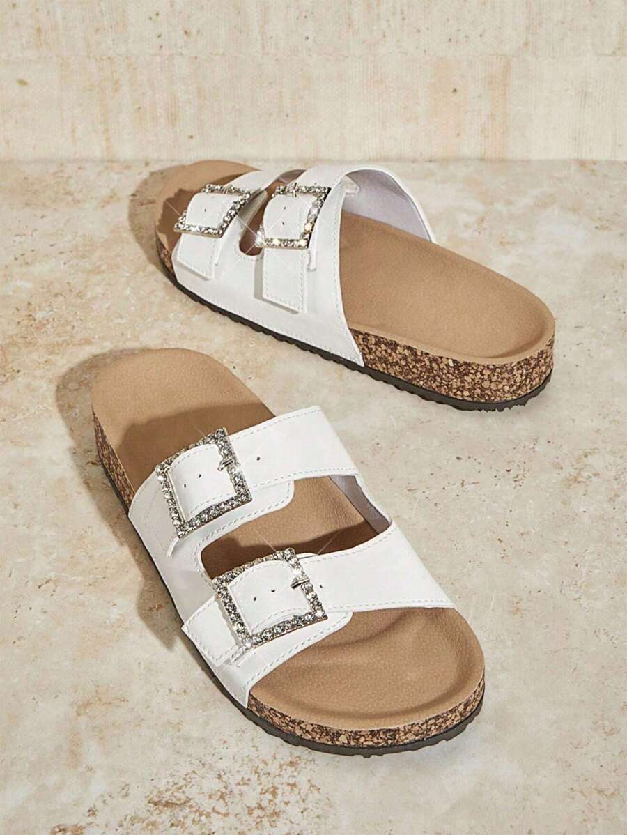 Step out in style and comfort with these elegant white cork sandals! Featuring a sparkling diamond buckle and a slip-resistant sole, they keep you looking chic while staying steady on your feet. Perfect for sunny days when you want a playful yet polished look.
