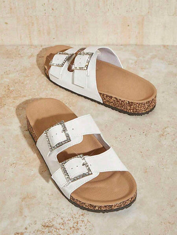 Step out in style and comfort with these elegant white cork sandals! Featuring a sparkling diamond buckle and a slip-resistant sole, they keep you looking chic while staying steady on your feet. Perfect for sunny days when you want a playful yet polished look.