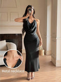 Front full-length view of black cowl-neck halter maxi dress with ruched waist
