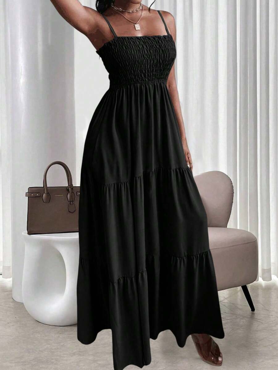 Black smocked tiered maxi sundress with thin straps and ruffle neckline