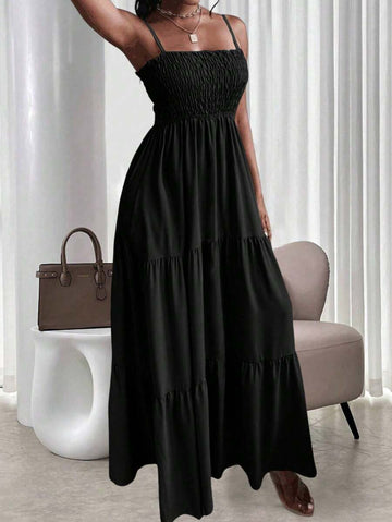Black smocked tiered maxi sundress with thin straps and ruffle neckline