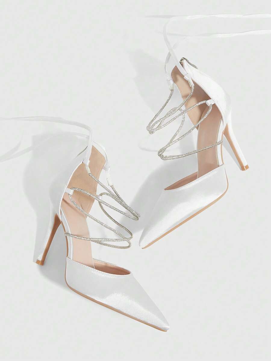 9 media show white black and pink satin pointed toe stiletto pumps with rhinestone crisscross instep cage straps, ankle wrap tie, side cutouts, tall back counter, back zipper. image 1