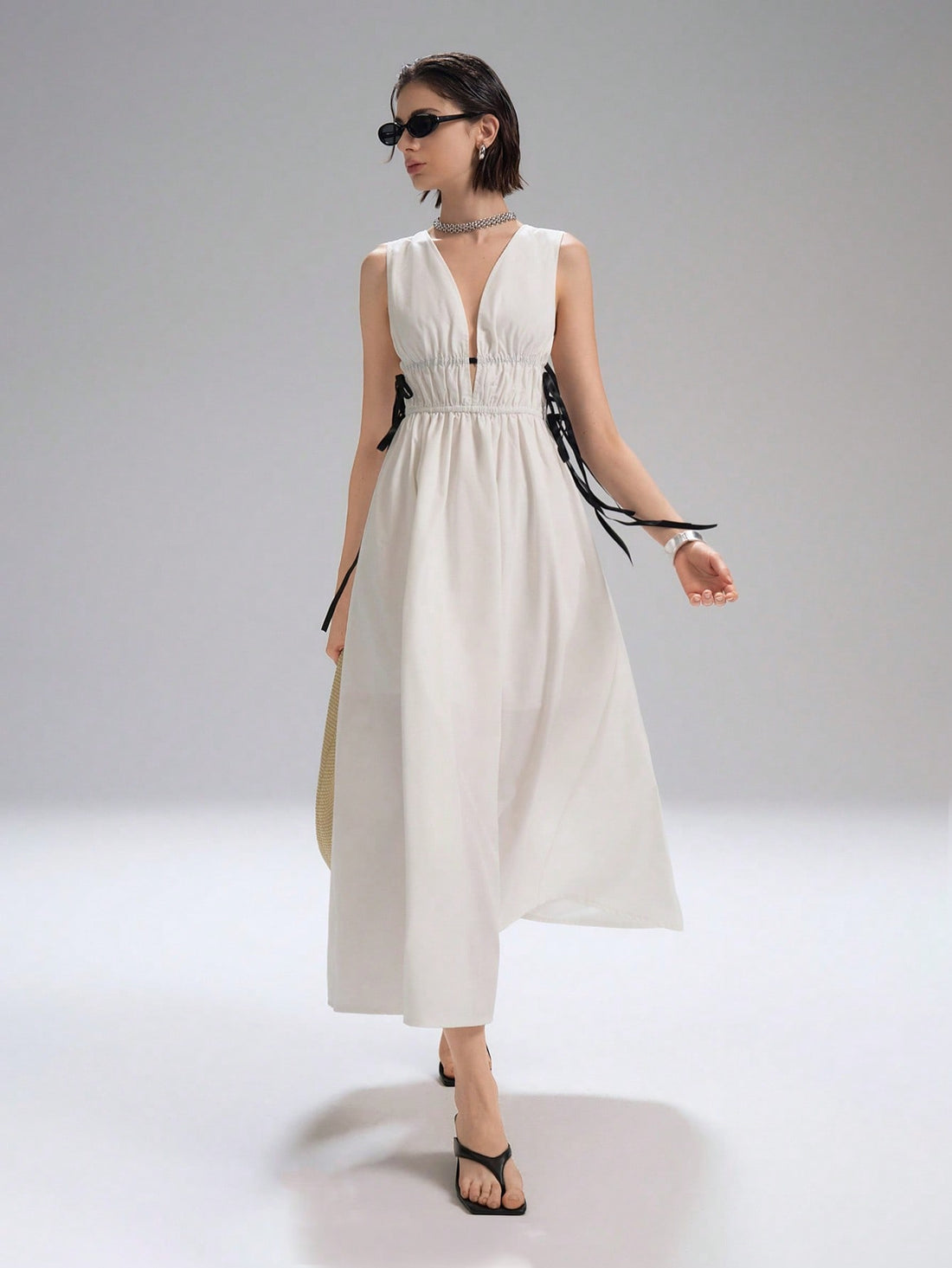 Step into summer with this playful white long dress featuring a flirty backless V-neck and charming ruched details. The waist tie adds a perfect touch to highlight your silhouette, making it an ideal choice for date nights or sunny outings. Light, elegant, and effortlessly stylish, this dress promises to keep you cool and captivating all day long.