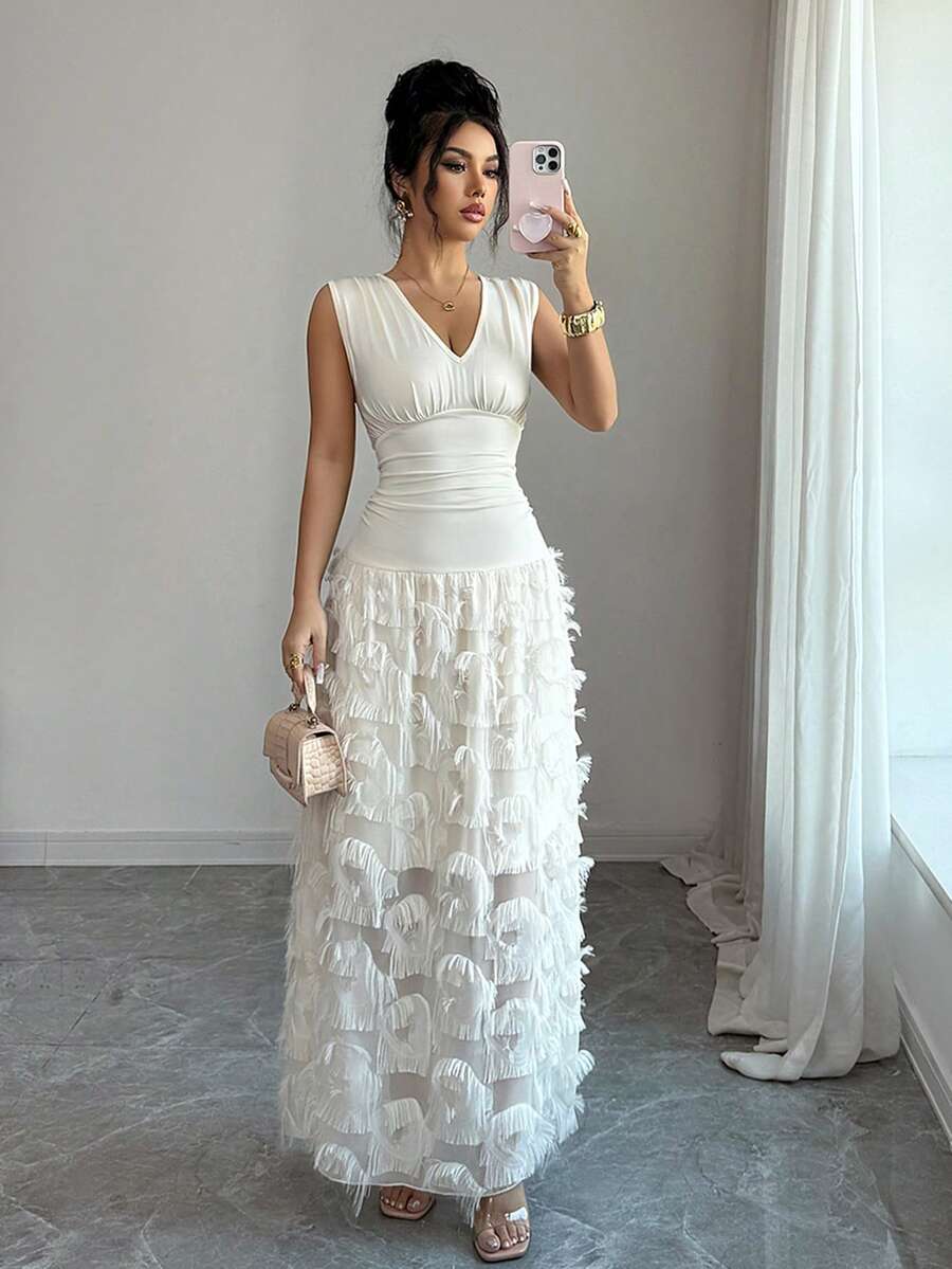 Elevate your summer wardrobe with this stunning chiffon tassel patchwork sleeveless dress. Designed for timeless elegance, this A-line silhouette features a flattering high waist, asymmetrical ruching, and a graceful flared hem. The V-neckline and plant-inspired pattern create a sophisticated look perfect for weddings and special occasions. Crafted from a premium blend of 90% polyester and 10% elastane with medium stretch, this knitted fabric offers comfort and durability. 