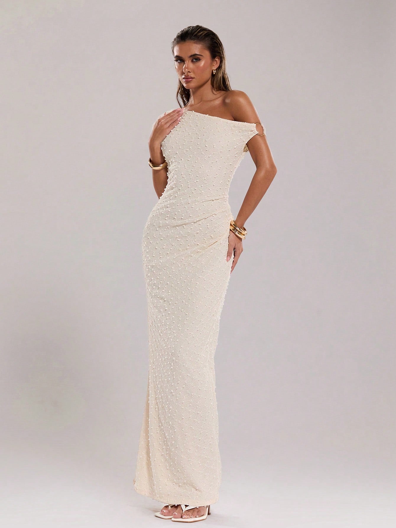 Get ready to rock the beach with this elegant summer maxi dress! Made from soft and breathable knitted crochet fabric, it boasts an asymmetric collar and a unique metal detail, adding a touch of edgy charm to your beach outfit. Make a statement while staying cool and comfortable.