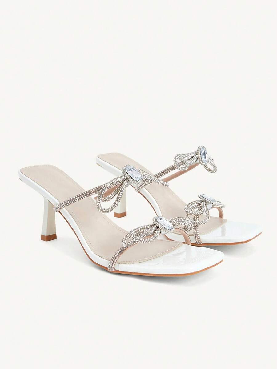 Step into elegance with these stunning rhinestone high heels, designed for the modern woman who loves to shine at special occasions. Featuring a chic square toe silhouette and delicate bow embellishments, these kitten heels offer the perfect balance of comfort and style. Crafted from premium PU leather with a soft fabric lining, they provide all-day wearability without sacrificing sophistication. 