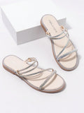 Beige rhinestone Roman flat slide sandals with nude footbed and tan sole