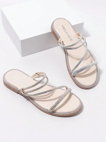 Beige rhinestone Roman flat slide sandals with nude footbed and tan sole