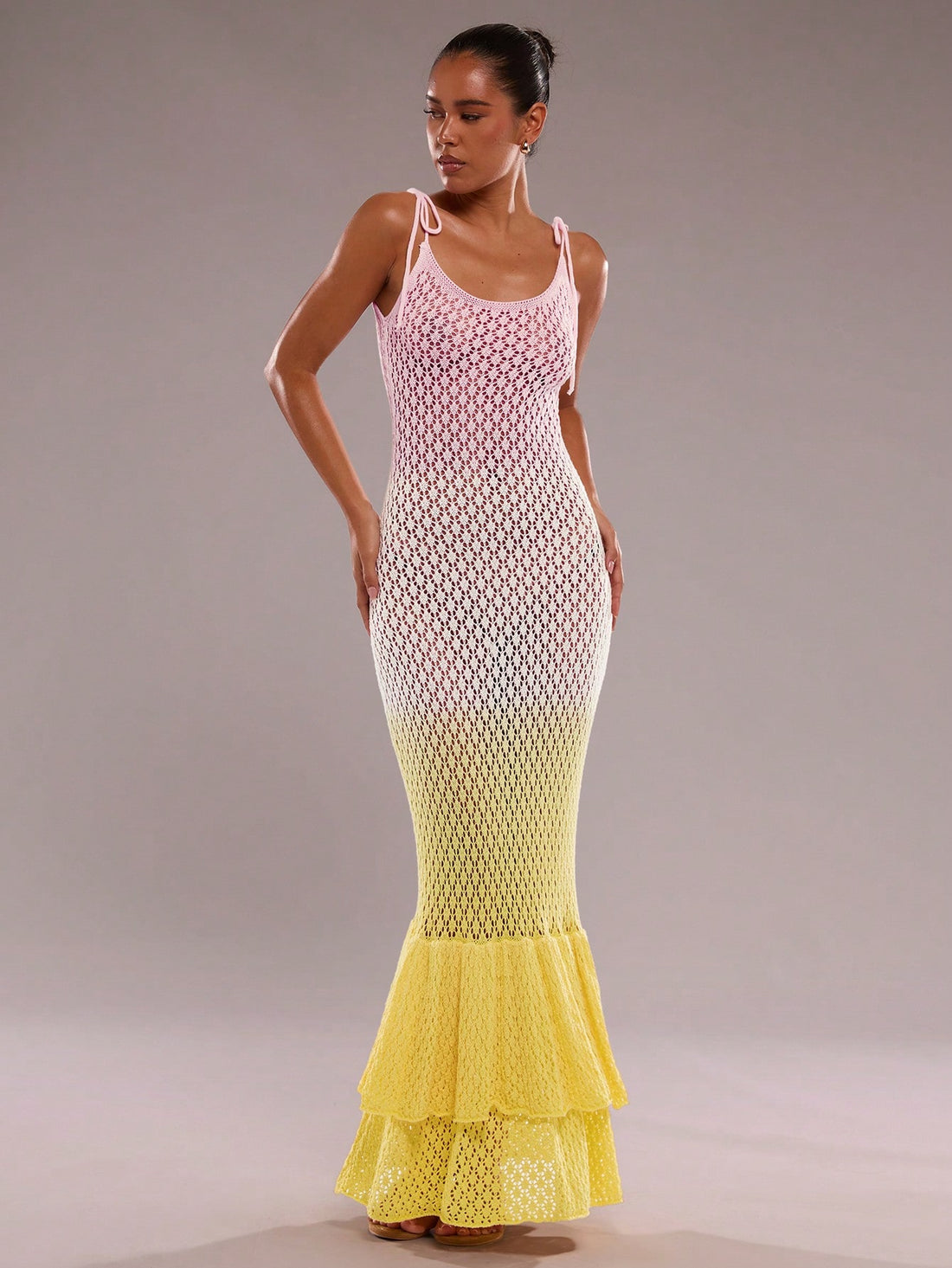 Step into summer with this playful fishtail knit dress, perfect for seaside adventures. Featuring charming ruffles and a stylish gradient hollow-out design, it combines comfort and flair effortlessly. Its breezy knit fabric keeps you cool while the fishtail silhouette adds a fun, flirty touch to your vacation wardrobe. Ideal for beach strolls or sunset dinners, this dress brings a splash of elegance to your sunny getaways.