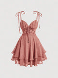 Elevate your wardrobe with this charming Swiss Dot Tie Shoulder Cami Dress. Featuring delicate spaghetti straps, a flattering ruched bust, and a distinctive two-layer tiered hem, this piece effortlessly transitions from casual outings to special occasions. The high-waist silhouette and knot detail at the shoulders add sophisticated touches, while the short length keeps things breezy and modern. Crafted from 100% polyester woven fabric in a rich redwood tone, it's perfect for graduation season