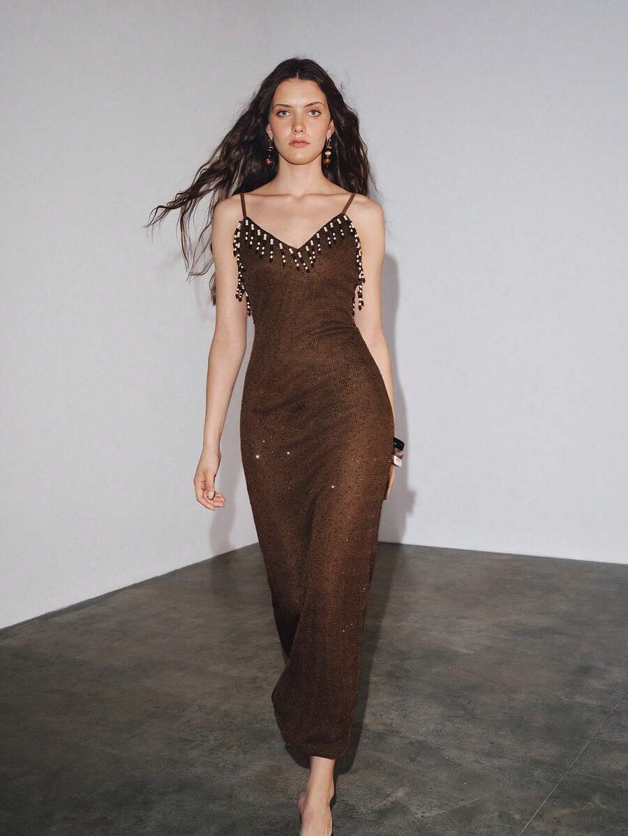 Styled view of brown beaded spaghetti strap knit maxi dress showing visible color, trim, and silhouette