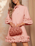 This elegant dress features a tiered ruffle hem and tie collar, making it the perfect addition to any woman's wardrobe. The tiered ruffle hem adds a touch of femininity and sophistication, while the tie collar adds a stylish and chic touch. Perfect for any occasion, this dress will elevate your look and make you feel confident and fashionable.