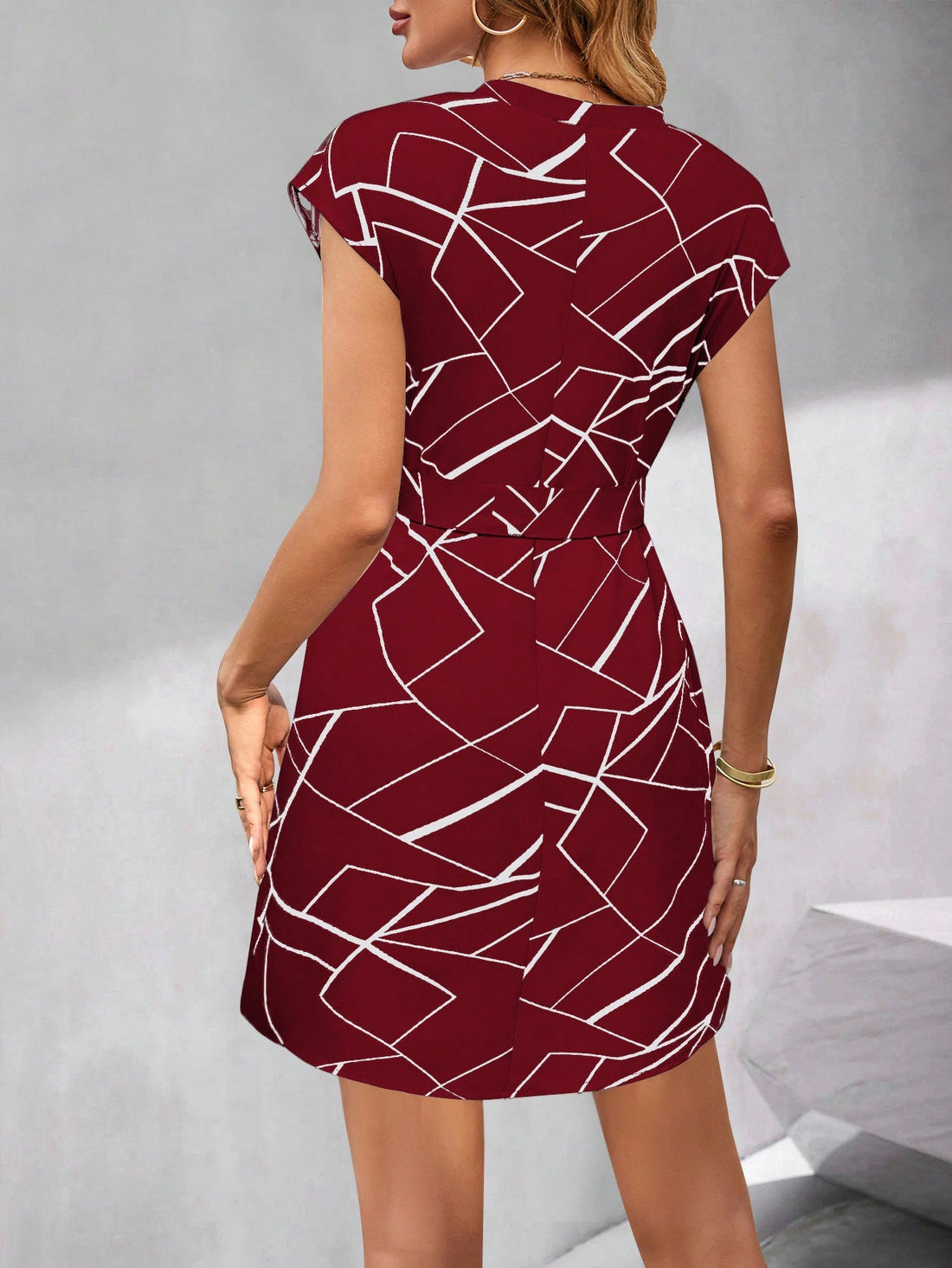 This elegant V-neck dress features a unique allover text print, adding a touch of sophistication to your wardrobe. The short sleeves offer comfort and versatility, while the waist tie accentuates your figure. Perfect for any occasion, this dress is a must-have for stylish, fashion-forward individuals.