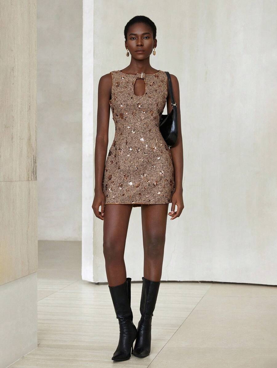 Step into timeless charm with this playful vintage-inspired brown tweed mini dress. Sparkle subtly with 3D sequin embellishments that catch the light at every turn, while the hollow neckline adds a flirtatious edge. Perfect for making memories, this dress blends classic style with a fun, modern twist.