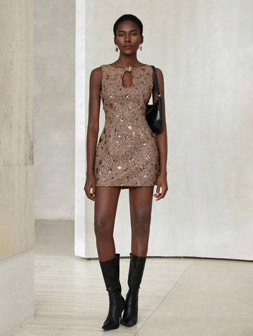 Step into timeless charm with this playful vintage-inspired brown tweed mini dress. Sparkle subtly with 3D sequin embellishments that catch the light at every turn, while the hollow neckline adds a flirtatious edge. Perfect for making memories, this dress blends classic style with a fun, modern twist.