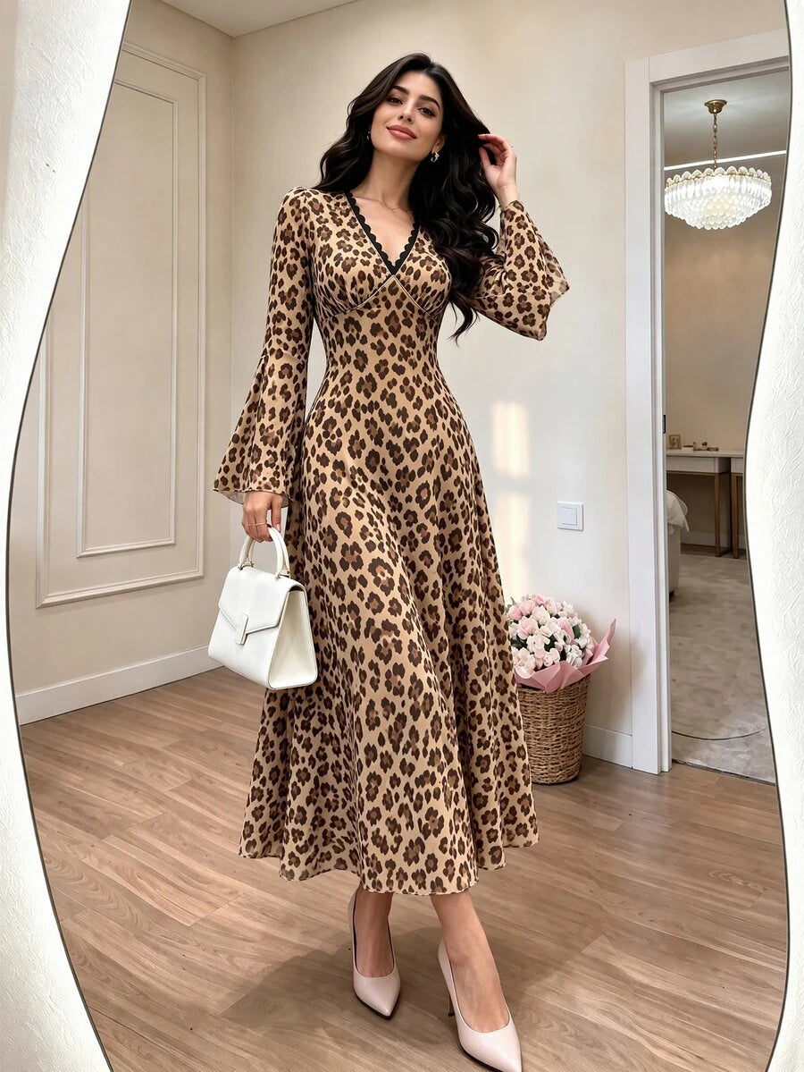 Front view of a tan leopard-print V-neck maxi dress with dark binding, fitted waist and flared long sleeves
