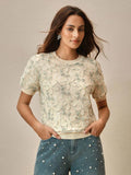 Slip into effortless sophistication with this charming vintage-inspired tee. The delicate sheer fabric in a gorgeous green hue brings an airy, romantic touch to your everyday wardrobe, while the thoughtfully designed cut flatters your silhouette beautifully. Perfect for layering or wearing solo, this short-sleeve essential bridges the gap between timeless elegance and modern comfort. Whether you're dressing up for brunch or keeping it casual, this piece adds that perfect dash of vintage charm to any outfit.