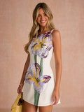 Front portrait of fitted white mini dress with oversized embroidered flower details