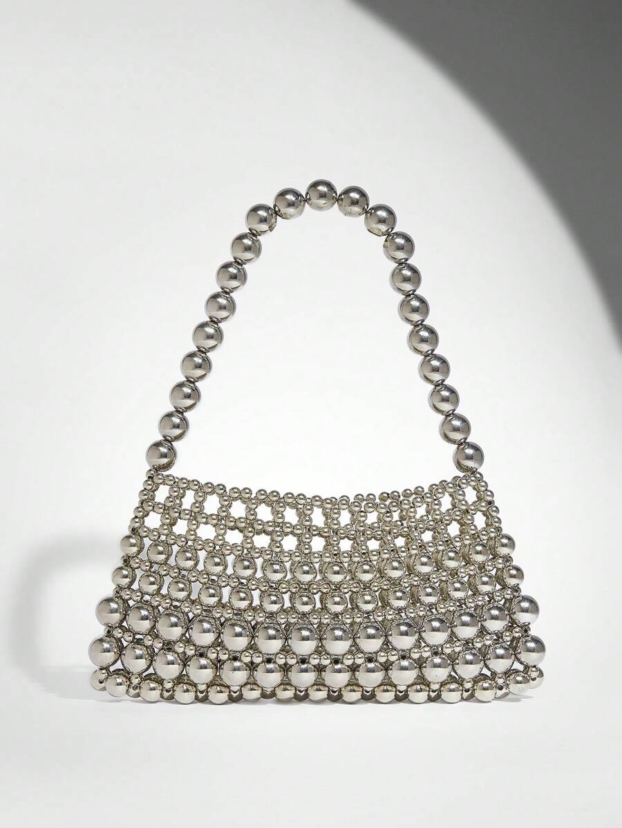 Add a touch of sparkle to your outfit with this Elegant White Pearl Beaded Shoulder Bag. Perfect for any occasion, its shimmering pearls and sleek design make it a playful yet sophisticated accessory that effortlessly elevates your style. Carry your essentials in chic fashion and turn heads wherever you go!