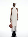 Step into summer with this Elegant White Satin Buckle-Back Fringe Maxi Dress, perfect for your boho-chic adventures. The silky satin fabric flows effortlessly, while the playful fringe and adjustable buckle-back add a flirty touch. Whether you're strolling the beach or dancing under the stars, this dress brings carefree style and comfort to your vacation wardrobe.