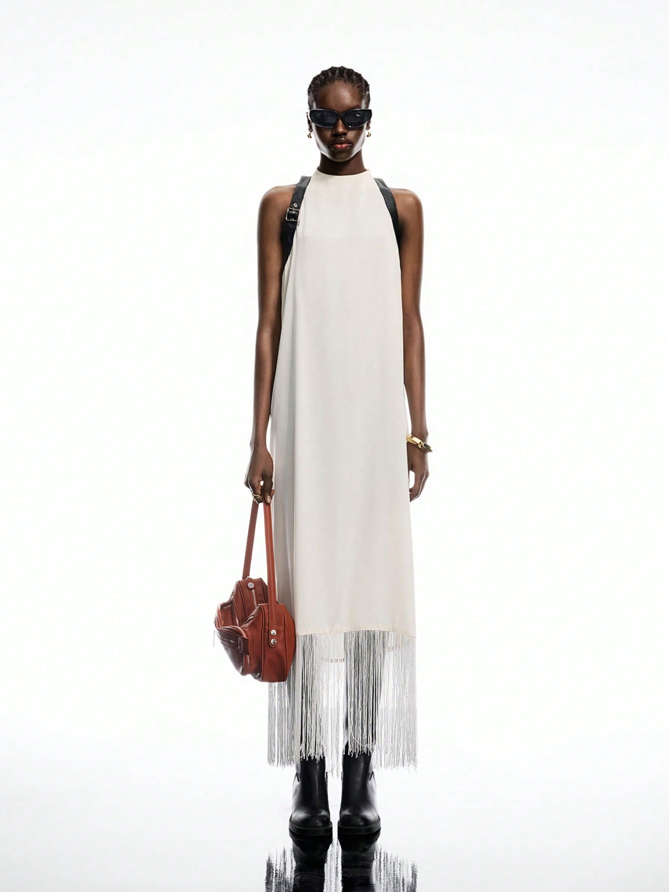 Step into summer with this Elegant White Satin Buckle-Back Fringe Maxi Dress, perfect for your boho-chic adventures. The silky satin fabric flows effortlessly, while the playful fringe and adjustable buckle-back add a flirty touch. Whether you're strolling the beach or dancing under the stars, this dress brings carefree style and comfort to your vacation wardrobe.