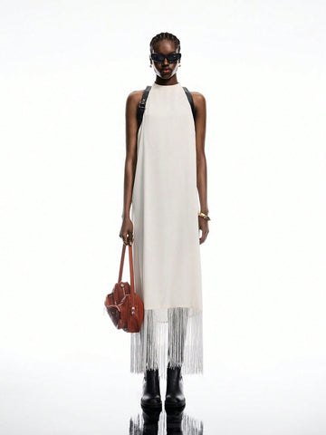 Step into summer with this Elegant White Satin Buckle-Back Fringe Maxi Dress, perfect for your boho-chic adventures. The silky satin fabric flows effortlessly, while the playful fringe and adjustable buckle-back add a flirty touch. Whether you're strolling the beach or dancing under the stars, this dress brings carefree style and comfort to your vacation wardrobe.