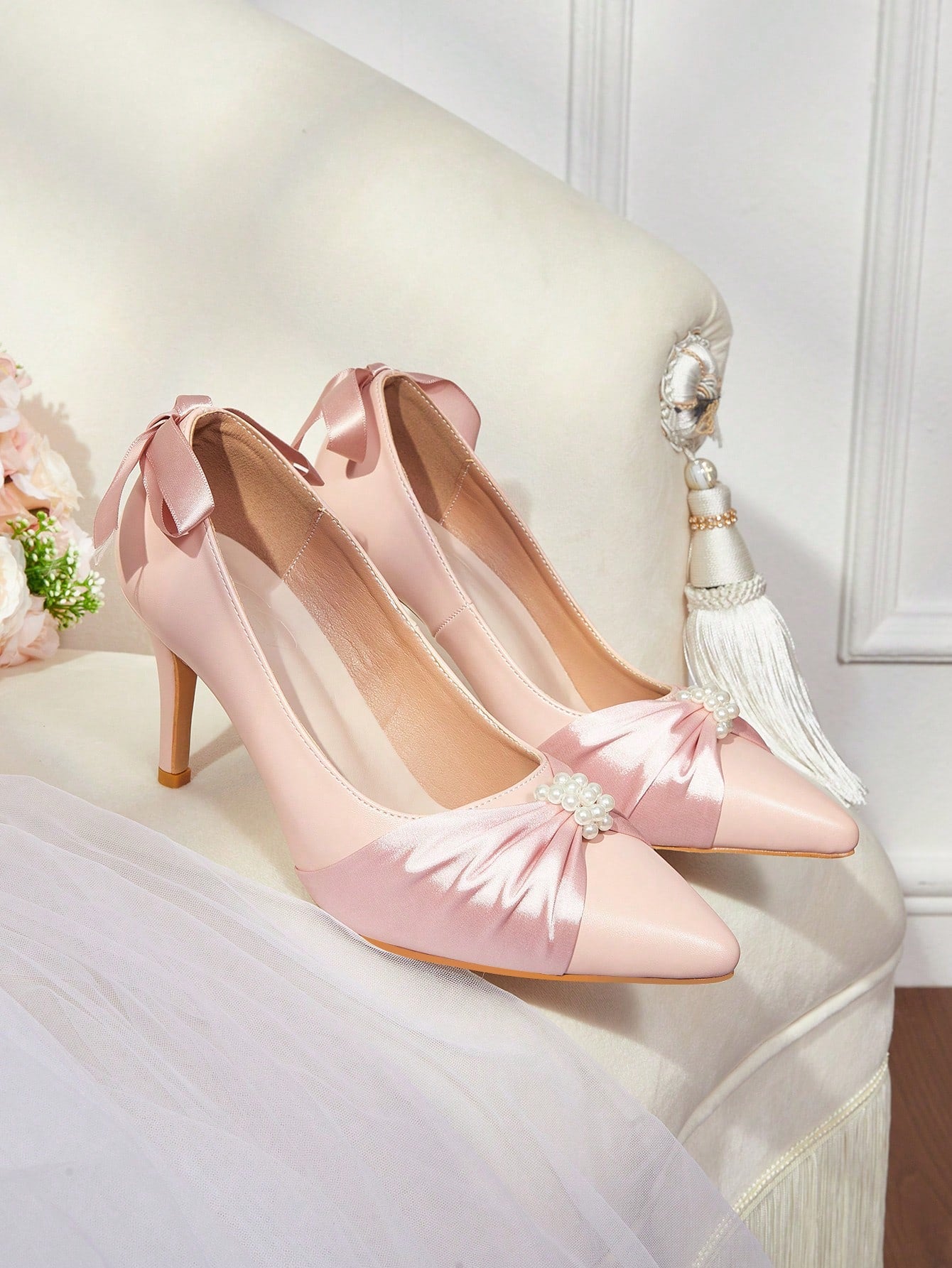 Enhance your formal look with our Elegant White Satin High Heel Pumps. The Faux Pearl Button Bow Detail adds a touch of sophistication to these classic shoes. Expertly crafted, these pumps provide both style and comfort for any occasion.