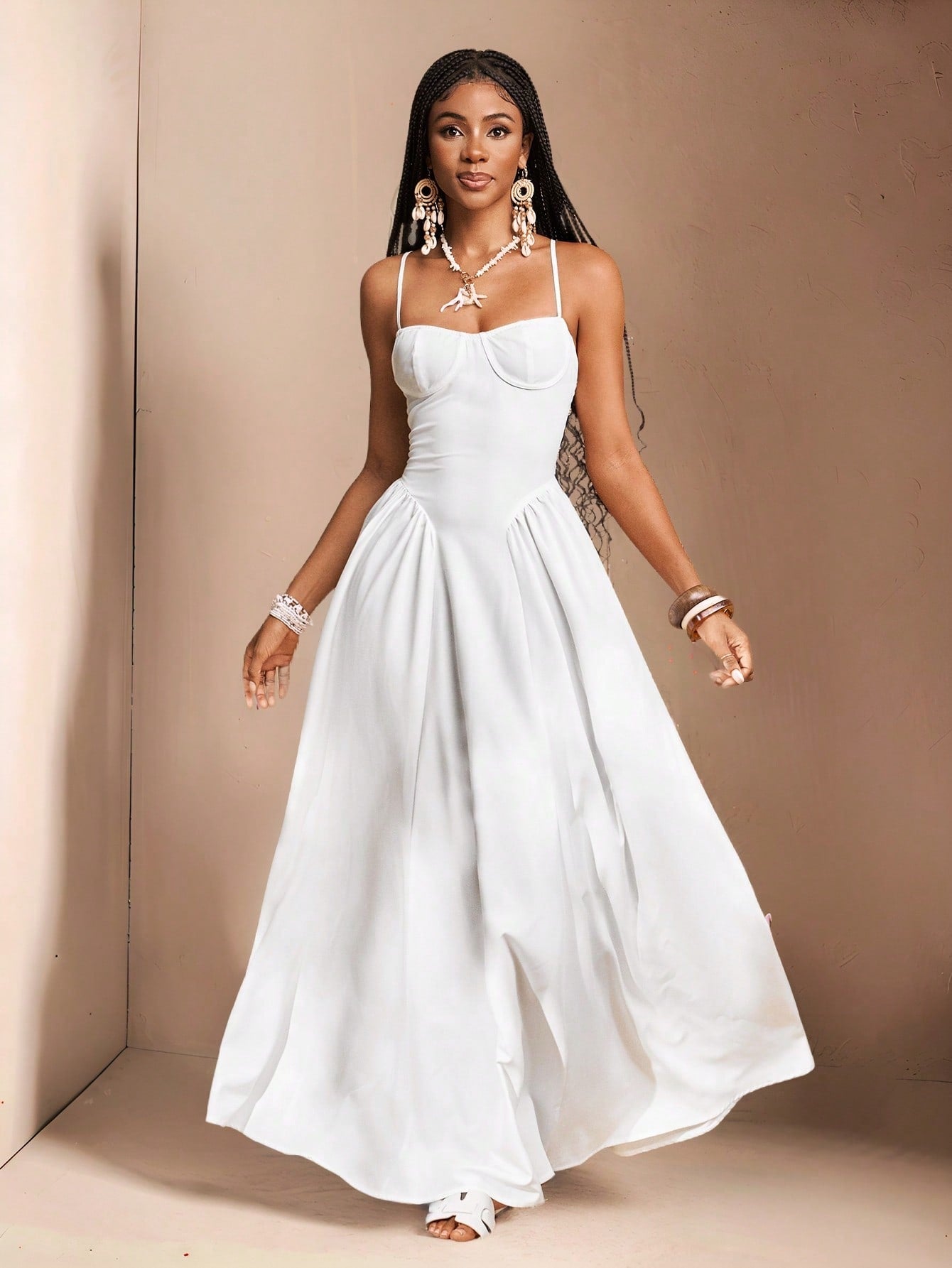 Get ready to slay this wedding season with our Elegant White Spaghetti Strap Dress! This stunning dress is perfect for spring and summer weddings, designed by Slaydiva for women who want to look stylish and chic. The long, flowy silhouette and delicate spaghetti straps will have you feeling like a true diva.