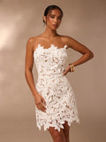 Make a statement in this stunning white tube top mini dress, where timeless elegance meets playful charm. The showstopping 3D flower embellishments add dimension and texture, transforming a classic silhouette into something truly unforgettable. Perfect for dancing the night away at parties, saying 