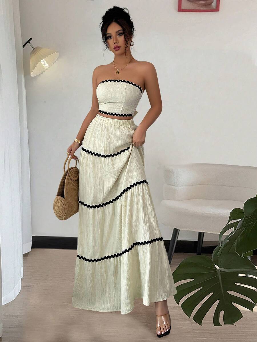 Elevate your wardrobe with this stunning two-piece set that's equal parts sophisticated and fun. The spliced ribbon bandeau top features a flattering silhouette that pairs perfectly with the coordinating skirt, creating an effortlessly chic look for any occasion. Whether you're heading to brunch, a night out, or a special event, this set delivers style without the fuss. The thoughtful ribbon detailing adds visual interest while keeping the overall vibe polished and put-together. Mix, match, or wear together