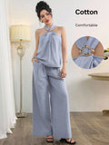 Elevate your warm-weather wardrobe with this chic two-piece set that's equal parts sophisticated and fun. The halter top features a striking metal buckle detail that adds instant glamour, while the flowing wide-leg pants offer comfort without compromising style. Perfect for brunch dates, evening strolls, or any occasion where you want to look effortlessly put-together. Mix, match, or wear together—this versatile duo works hard so you don't have to.