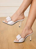Step into unparalleled sophistication with these elegant high heel slide sandals, meticulously designed to be the ultimate finishing touch for weddings and formal celebrations. Featuring a sleek pointed-toe silhouette and an exquisite bow adornment, these shoes strike a perfect balance between classic romance and contemporary chic. The convenient slide-on design offers effortless wearability, while the refined heel height provides a graceful lift without compromising on comfort for a long day of festivities
