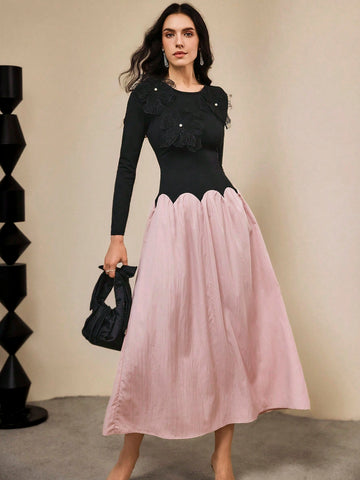 Make a statement in this stunning color block dress that perfectly blends sophistication with fun! Featuring a striking black and purple palette, this elegant piece showcases intricate 3D floral accents that add dimension and visual interest. The flowing silhouette is finished with a playful wavy hem that catches every step you take. Perfect for special occasions, evening events, or whenever you want to turn heads with effortless style. This dress proves that elegance doesn't have to be boring—it can be bol