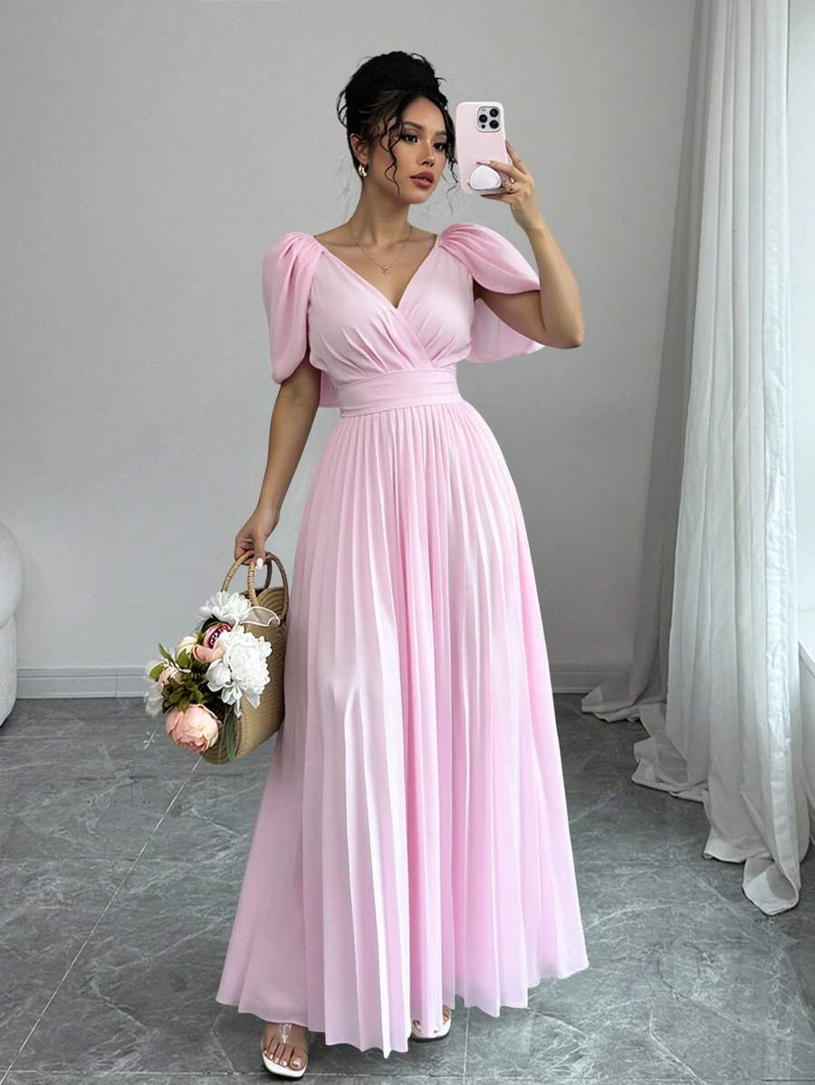 Dress to impress with this elegant off-shoulder dress. The v-neck and ruched waist add a touch of femininity, perfect for special occasions. Stay stylish and comfortable in this versatile piece.