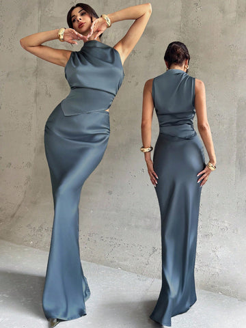 Elevate your workweek wardrobe with this chic two-piece set that effortlessly transitions from boardroom to brunch. The sleeveless shirt features a crisp pleated collar that adds instant polish, while the high-low midi skirt brings modern flair with its asymmetrical hem. Crafted in luxurious blue satin, this pairing delivers that "I woke up like this" sophistication—because looking put-together shouldn't feel like work. Perfect for professionals who refuse to compromise on style.