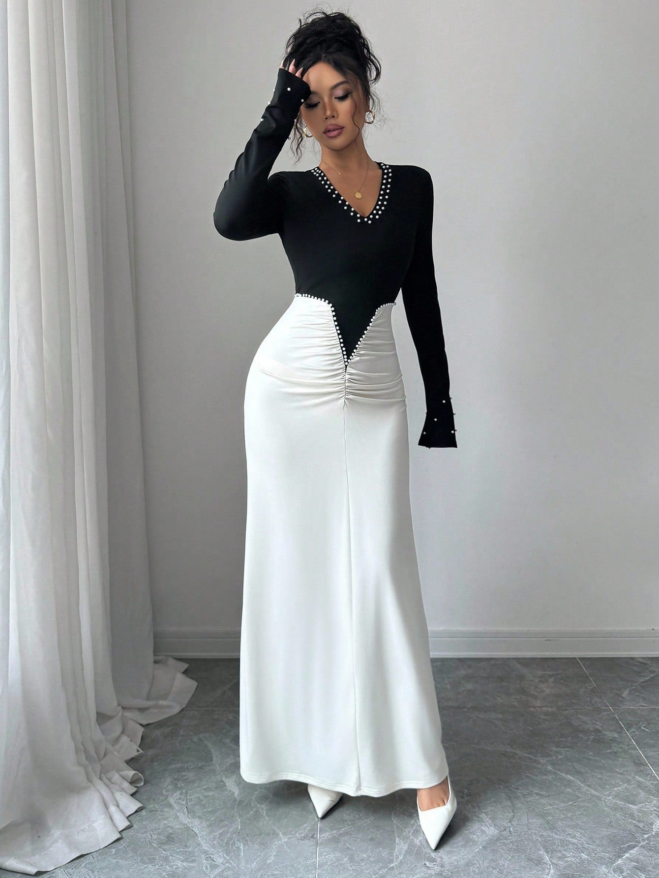 Slip into sophistication with this stunning pearl-adorned bodycon dress that's ready to turn heads at any celebration. The high-waist silhouette flatters your figure while pleated maxi detailing adds graceful movement and dimension. Perfect for formal galas, birthday bashes, and those moments when you want to feel absolutely fabulous. The delicate pearl embellishments catch the light beautifully, giving you that extra sparkle without trying too hard. Whether you're dancing the night away or making a grand e