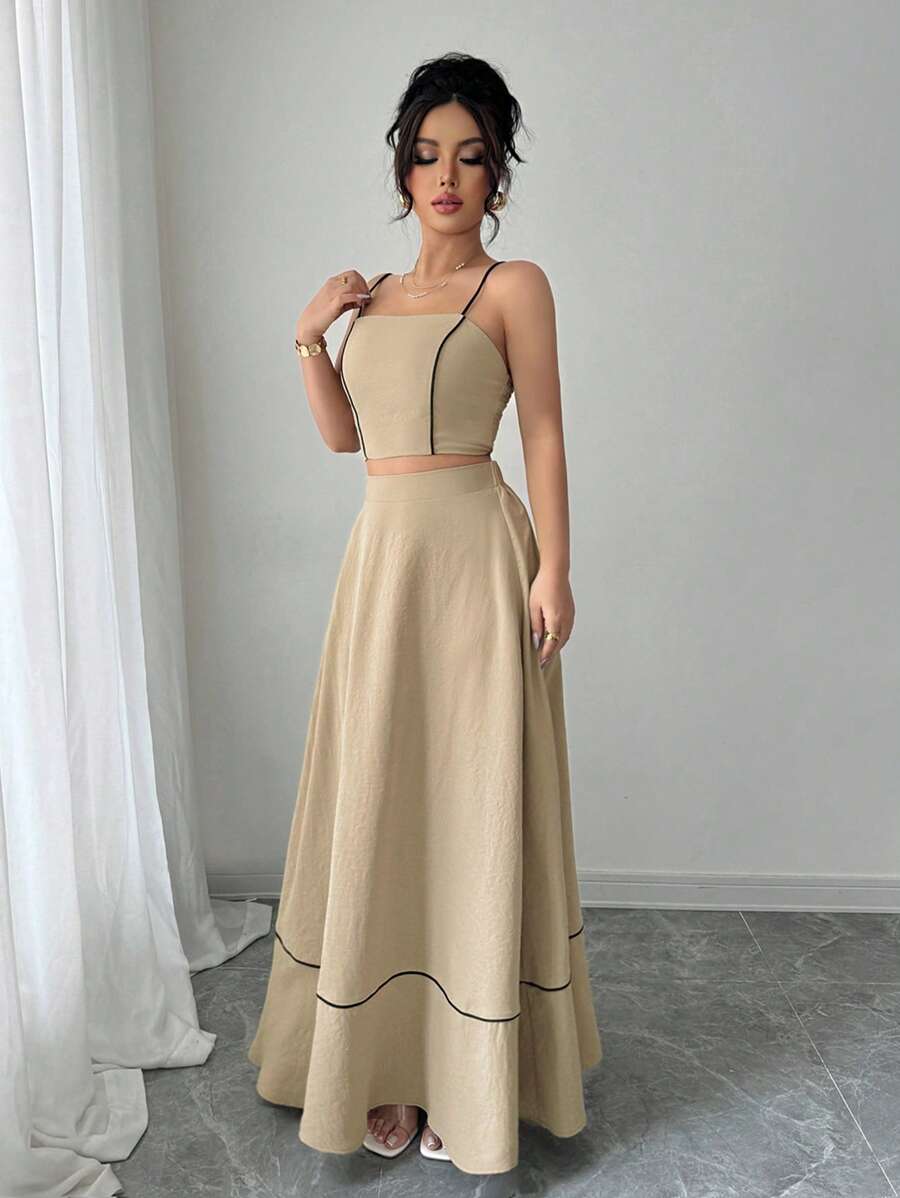 Escape to your own bohemian paradise with this dreamy two-piece set! The delicate spaghetti strap camisole pairs perfectly with a flowing A-line maxi skirt, creating an effortlessly chic silhouette that's ready for vacation vibes or everyday elegance. Soft, breathable fabrics move with you while the romantic design turns heads wherever you go. Whether you're lounging by the pool or exploring a new destination, this set delivers comfort without compromising on style. Your wardrobe just got a whole lot more f