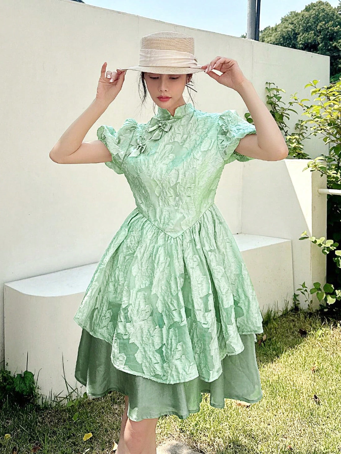 Embrace timeless charm with this elegant Chinese-style dress featuring a stand collar and playful bow detail. Its flared skirt effortlessly creates a slimming silhouette, perfect for twirling through your day with grace and fun. Add a touch of cultural flair and flattering style to your wardrobe!