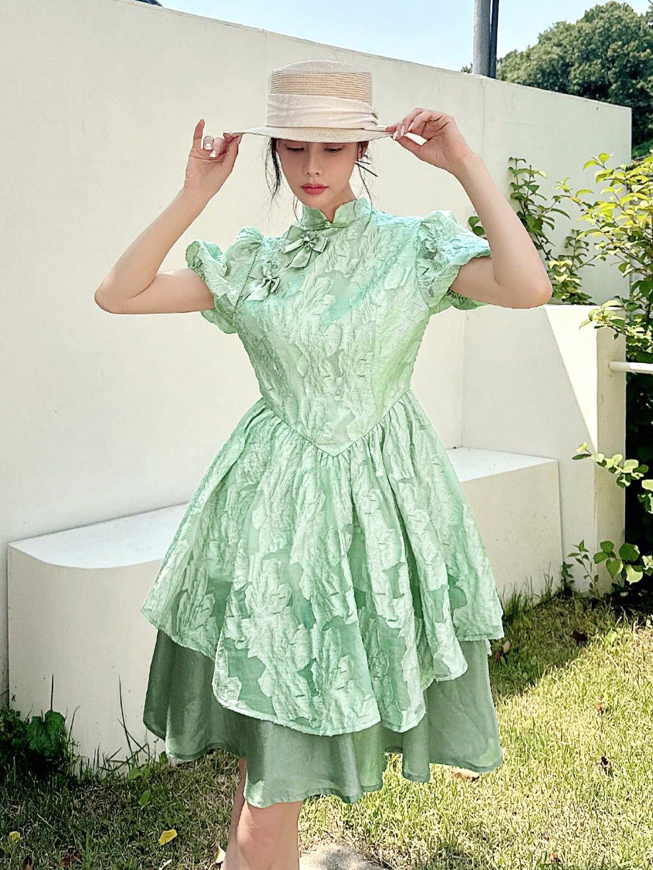 Embrace timeless charm with this elegant Chinese-style dress featuring a stand collar and playful bow detail. Its flared skirt effortlessly creates a slimming silhouette, perfect for twirling through your day with grace and fun. Add a touch of cultural flair and flattering style to your wardrobe!