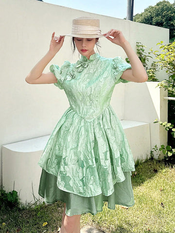 Embrace timeless charm with this elegant Chinese-style dress featuring a stand collar and playful bow detail. Its flared skirt effortlessly creates a slimming silhouette, perfect for twirling through your day with grace and fun. Add a touch of cultural flair and flattering style to your wardrobe!