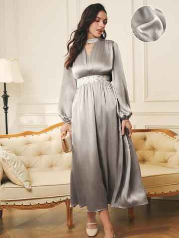 Elevate your winter wardrobe with this stunning maxi dress that's equal parts sophisticated and fun! Crafted from luxurious textured satin, it features charming ruffle detailing that adds movement and personality to every step. Whether you're heading to a holiday party or layering it over your favorite turtleneck for everyday elegance, this versatile piece delivers. The flowing silhouette flatters all figures while the rich fabric catches the light beautifully. Dress it up with heels and statement jewelry, 