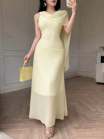 Front view of pale yellow asymmetrical draped chiffon maxi dress showing visible color, trim, and silhouette