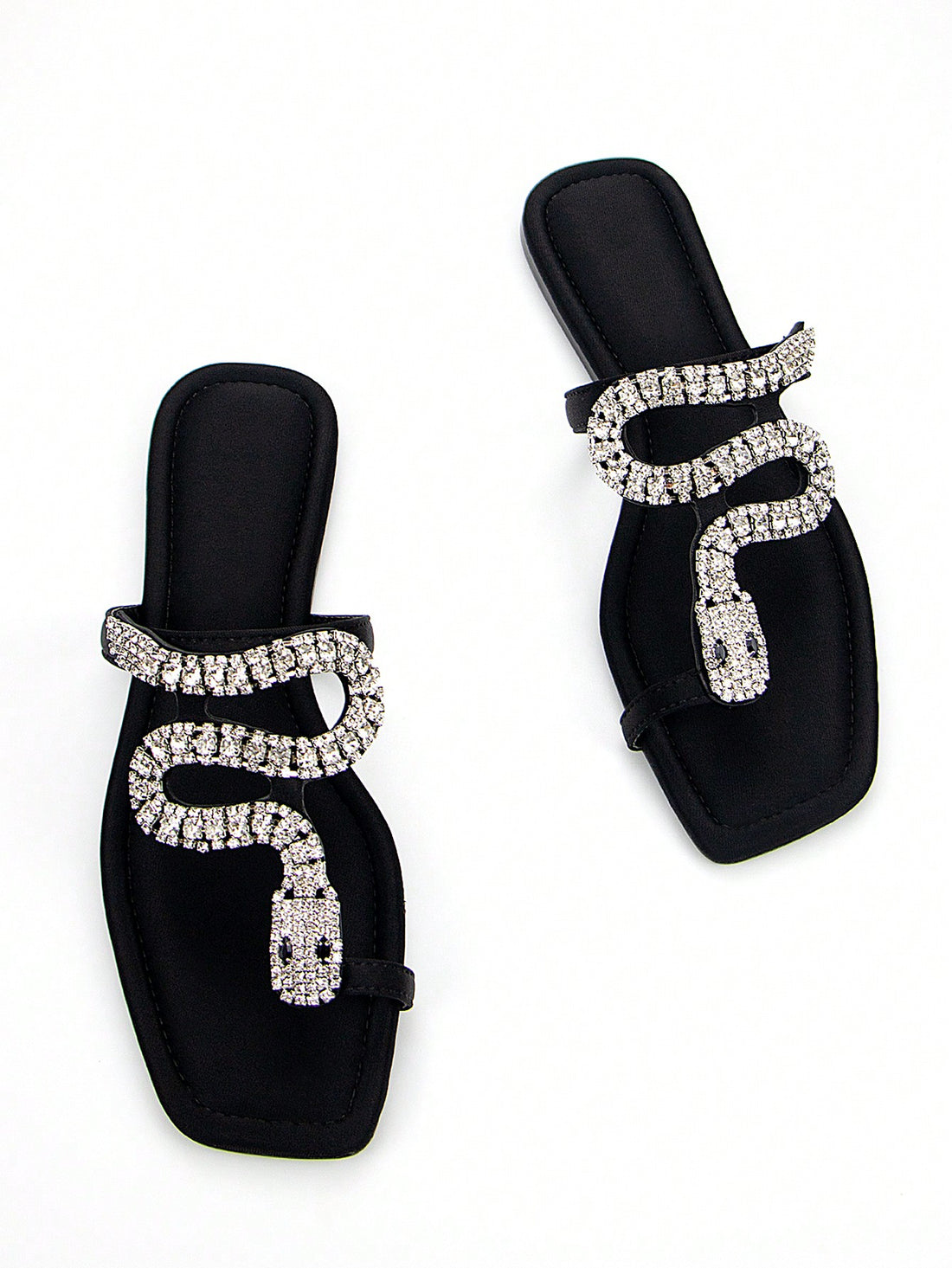 Discover the ultimate combination of elegance and comfort with our Elegantly Chic 3D Snake Crystal Chain Black Lycra Slip-On Flat Mule Sandals. Featuring a stunning 3D snake crystal chain design and a slip-on style for easy wear, these sandals are perfect for any occasion. Walk in style and comfort with our chic and trendy flats.